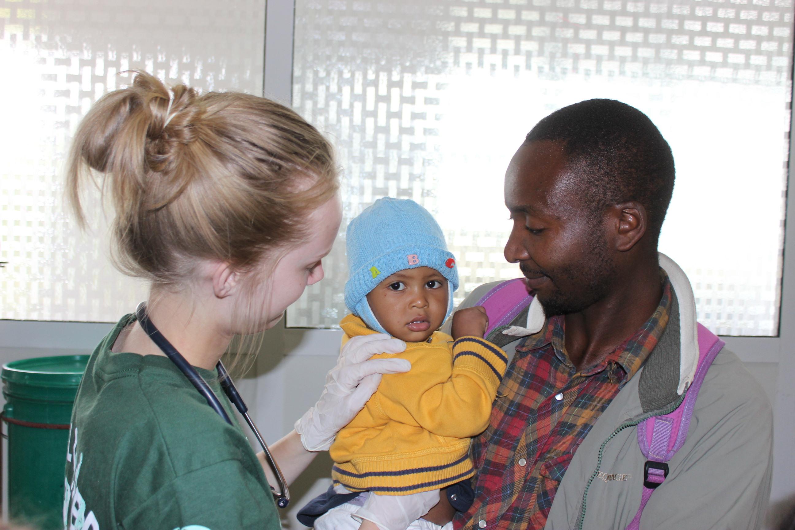 An intern with Projects Abroad checking a babys heart beat in local medical centre as part of her midwifery internship in Tanzania. Projects Abroad intern checking a baby's heart beat during her midwifery internship in Tanzania.